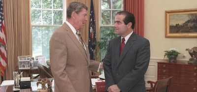 File photo of U.S. President Ronald Reagan speaking with Supreme Court Justice nominee Antonin Scalia in the White House Oval Office
